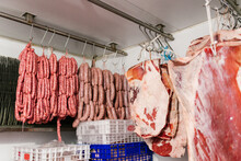 Row Of Raw Sausages And Meat Hanging On Hanger