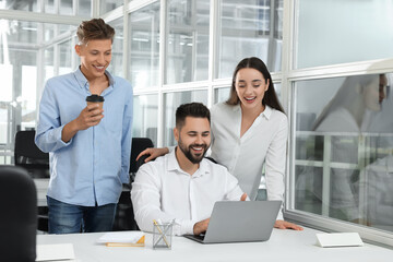 Canvas Print - Colleagues working together in open plan office