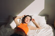 © Amor Burakova/Stocksy - Young woman relaxing at the bed