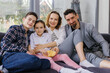 © Oleksii Syrotkin/Stocksy - Family portrait happy children home parent eye contact