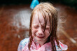 © Amanda Voelker/Stocksy - Little Girl crying in the rain