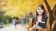 © pinkrabbit - Beautiful student asian woman with backpack and books outdoor. Smile girl happy carrying a lot of book in college campus. Portrait female on international Asia University. Education, study, school