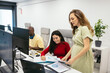 © Pedro Merino/Stocksy - Pregnant woman and cheerful young woman reviewing documents in office