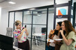 © Pedro Merino/Stocksy - Business people taking photos with smartphone during an office party
