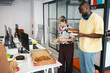 © Pedro Merino/Stocksy - Workers celebrating a party in the office eating pizza and cake