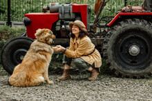An Attractive Country Girl Trains Her Red-haired Dog On A Ranch