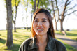 © Rob and Julia Campbell/Stocksy - Happily smiling woman in front of a tree, showing teeth.
