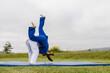 © ByLorena/Stocksy - Teenagers training judo in park