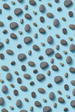 Blue Background With Black Pebble Stones.