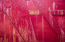 Red, Rusty Metal Plates With Rivets