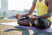 Man Meditating In Lotus Position On Yoga Mat  Holding Prayer Beads