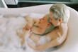 © Alexey Kuzma/Stocksy - Happy Couple relaxing in the bath