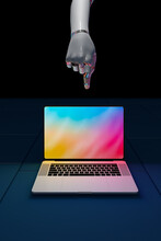 Robot Hand Pointing At Laptop