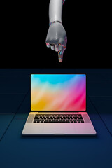 Robot hand pointing at laptop