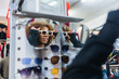 © Daniel Gonzalez/Stocksy - Stylish black woman buying sunglasses in market