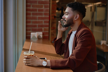 Happy Man Using Phone In Cafe