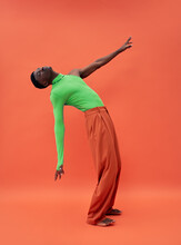 Black Fashionable Man Model Posing In Studio On Red Background