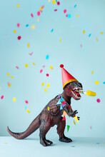 Toy Dinosaur Celebrating At A Birthday Party