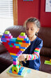 © Anya Brewley Schultheiss/Stocksy - Child building a heart shaped structure with vibrant blocks