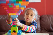© Anya Brewley Schultheiss/Stocksy - Child building a structure with bright coloured blocks.