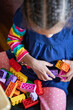 © Anya Brewley Schultheiss/Stocksy - Closeup of a child's as she plays with blocks