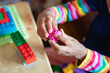 © Anya Brewley Schultheiss/Stocksy - Closeup of a child's hands as she plays with blocks