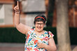 © Santi Nuñez/Stocksy - Joyful portrait of a mentally challenged woman laughing outdoors.