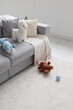 © Danil Nevsky/Stocksy - Toys on floor and on sofa in modern apartment