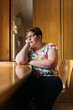 © Santi Nuñez/Stocksy - portrait of thoughtful woman with intellectual disabilities