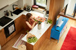 © Boris Jovanovic/Stocksy - Woman arranges flowers in the kitchen
