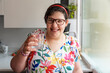 © Santi Nuñez/Stocksy - Joyful portrait of a mentally challenged woman smiling at home