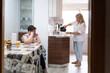 © Santi Nuñez/Stocksy - Handicapped woman in household chores