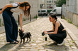 © Léa Jones/Stocksy - young woman petting her little dog  in Paris