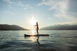 © Marko/Stocksy - Woman on SUP paddle board