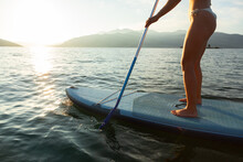 Woman On SUP Paddle Board 