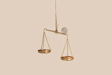 Coin On Top Of Golden Empty Scales.