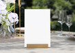 Mockup white blank space card, for greeting, table number, wedding invitation template on wedding table setting background. with clipping path. 3D rendering