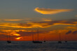 Bright orange sunset with sailboat silhouettes taken from Front Street, Lahaina, Maui, Hawaii