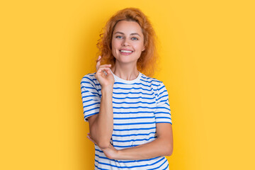 Wall Mural - happy redhead woman portrait isolated on yellow background. portrait of young redhead woman