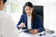 © Fahng - lawyer having meeting and consoling solution to her clients provide legal advice and trust commitment strain serious for problem, justice and attorney concept
