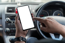 Mockup Of Man Driver Hand Using Blank White Screen Mobile Smart Phone Inside A Car, Searching Location Via Gps Navigator Application, Close Up
