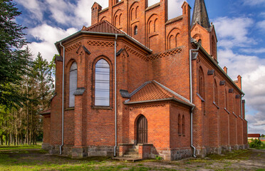 Wall Mural - General view and close-up architectural details of the Catholic Church of St. Holy Trinity in the town of Dwawrzuty in Masuria in Poland.