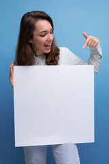 Canvas Print - european active 25 year old young brown-haired woman demonstrating business project on white board with mockup