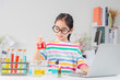 © Tanatpong - Asian little girl working with test tube science experiment in white classroom