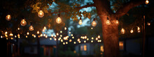 Outdoor String Lights Hanging On A Line On Outside House In Backyard. Garden Decoration. Party Camping