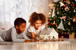 © the_lightwriter - black kids celebrate Christmas with gifts