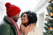 © Jasmina - Closeup photo of cute couple spending holly Christmas eve in decorated garland lights house near Chrismas tree outdoors
