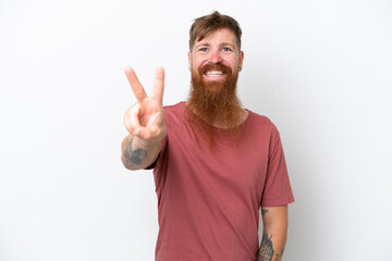 Redhead man with long beard isolated on white background smiling and showing victory sign