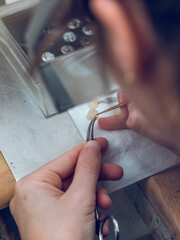 Anonymous dental technician coloring ceramic teeth