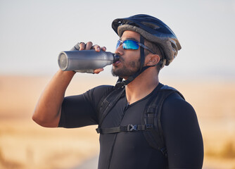 Wall Mural - Fitness, health and man cyclist drinking water at race, marathon or competition training. Sports, workout and thirsty male athlete with hydration for wellness at an outdoor cardio exercise in nature.